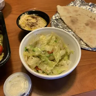 The dish sides of green salad, baba gannoush, pita and garlic paste.