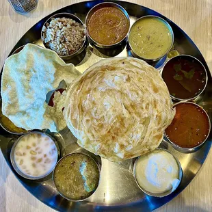 South Indian Thali - the mound of rice is buried under the paratha