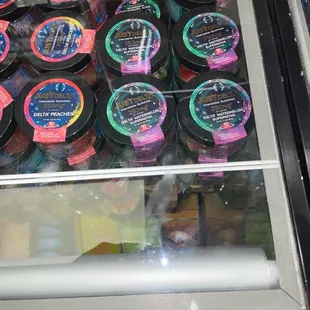 a display case full of different flavored ice creams