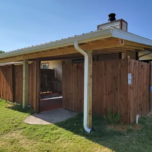 a covered patio with a dog sitting on the roof