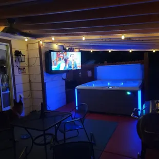 a hot tub lit up at night