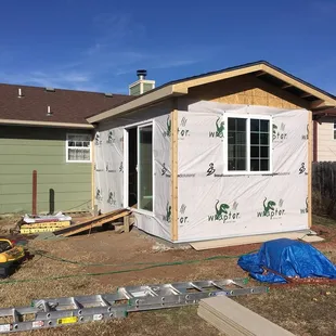 Room addition in Garden Plain, Ks. Structure is framed, roof is decked, windows and door is installed...
