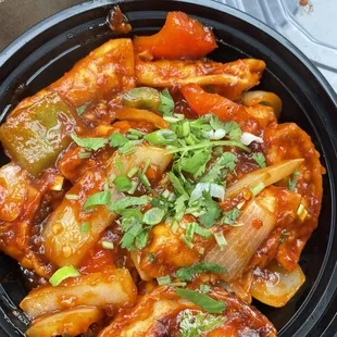 Chicken chili momo-- Spiced chicken dumplings in medium hot sweet and sour sauce with bell peppers and onions