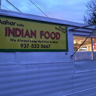 a food truck with a sign for indian food
