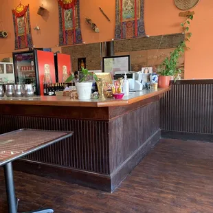 a restaurant with a wooden bar and tables