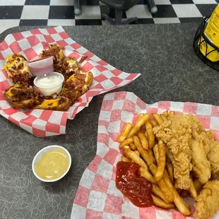 good food. chicken strip basket with fries. loaded potato skins. with dipping sauces