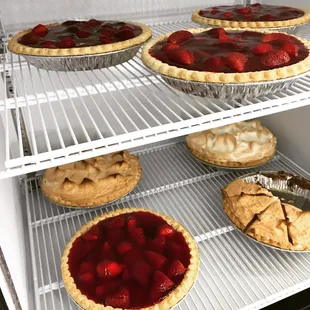 a variety of pies in a refrigerator