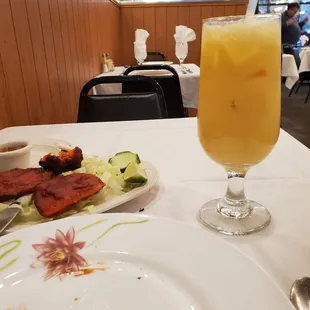 a plate of food and a glass of orange juice