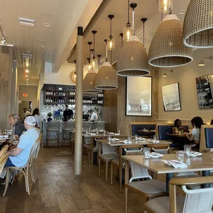 people sitting at tables in a restaurant