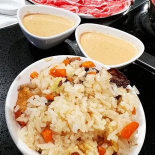 a plate of rice with meat and vegetables