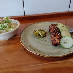 a plate of food and a bowl of salad