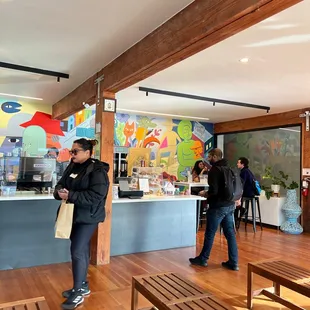 two people standing in a coffee shop