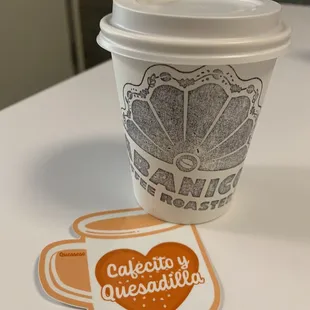 a cup of coffee and a sticker