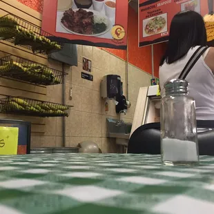 a woman sitting at a restaurant counter