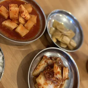 three bowls of food on a table
