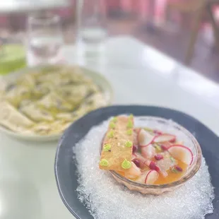 Local Fish Ceviche: harissa-leche de tigre, pomegranate, avocado, red onion, cilantro, jalapeño, pita crisp.