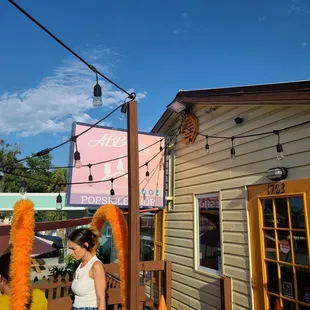 a woman standing outside of a restaurant