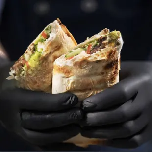 Lamb Shawarma Wrap: Tender lamb shawarma, fresh minced parsley, tomato, onion, 5-herb green sauce, and house garlic sauce, in tortilla.