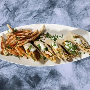 Chicken Arabi: Stuffed with crowd-favorite special recipe chicken shawarma, creamy, house-made garlic sauce, crispy pickle, and fresh fries.