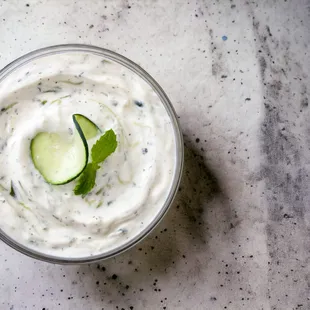 Taziki: Creamy, organic greek yogurt dip infused with fresh mint, crisp chopped cucumber, minced garlic, and zesty lemon. Gluten Free.