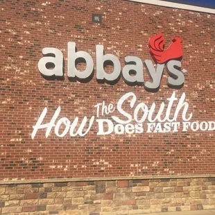 a brick building with a sign that says the south hour does fast food