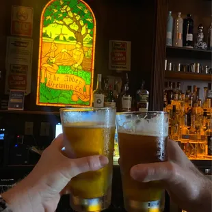 two people toasting at a bar