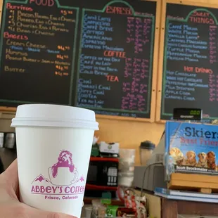 a hand holding a cup of coffee