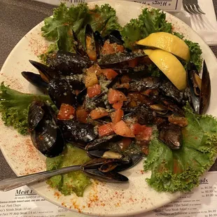 a plate of mussels and tomatoes
