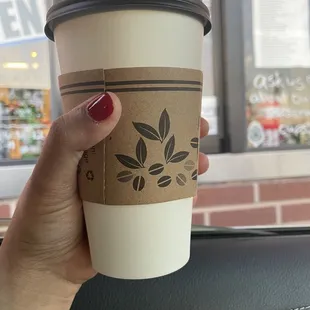 a hand holding a coffee cup