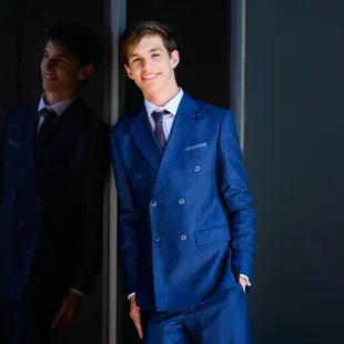High School senior boy posing for pictures wearing a suit in Kansas City.