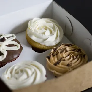 chocolate cherry, vanilla with vanilla, vanilla on chocolate, and caramel cupcakes
