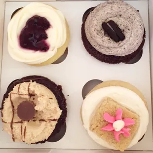 Lemon blueberry, sugar cookie, cookies n cream, and peanut butter chocolate cupcakes