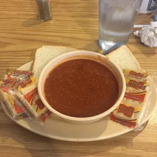 a bowl of soup and chips on a plate