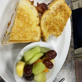 Bacon and turkey sandwich with fruit salad