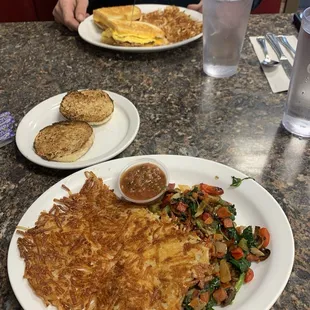 Veggie omelette no eggs or cheese with well done hash browns and a breakfast sandwich