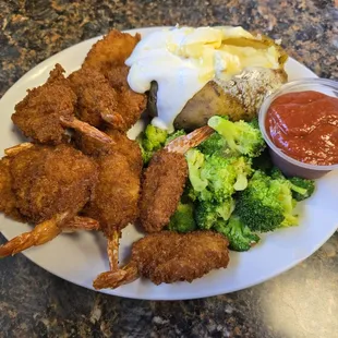 Fried shrimp,broccoli and baked potato with butter and sour cream.