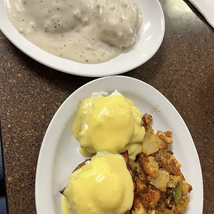 Eggs Benedict, crispy breakfast potatoes, small side of biscuits and gravy