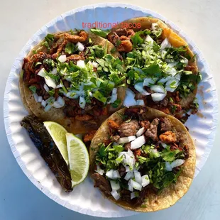 three tacos on a paper plate