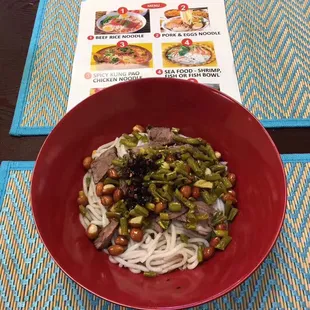 a bowl of noodles and broccoli