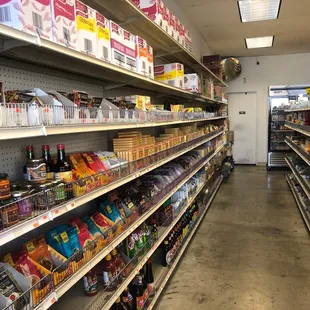 a supermarket aisle with shelves full of goods