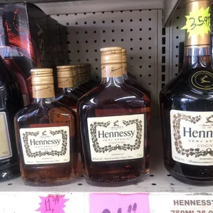 bottles of henness on a shelf