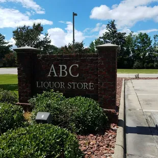a brick sign in a parking lot