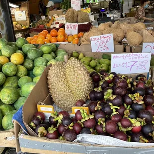Husked coconuts, fresh papayas, durian and mangosteen