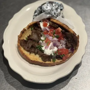 a plate with a pita sandwich on it