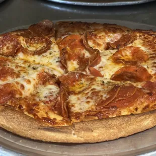 a pepperoni pizza on a pan