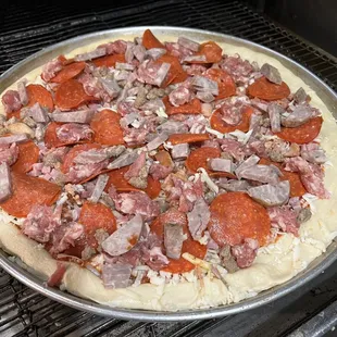 a pizza with meat and pepperoni