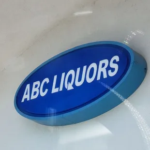 a blue and white sign for abc liquors