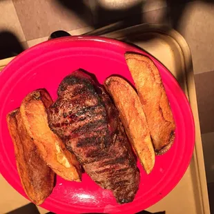 a plate of steak and french fries