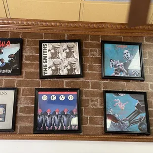 a brick wall with various posters on it