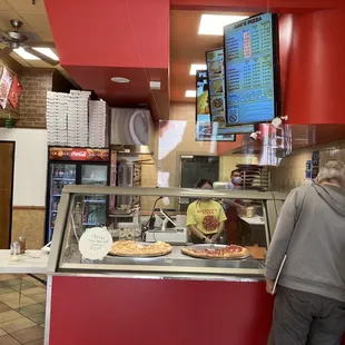 Counter with display of menu and pizzas
